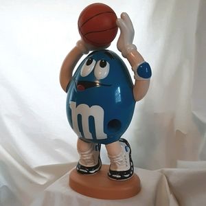 M&M candy dispenser. Blue M&M playing basketball.